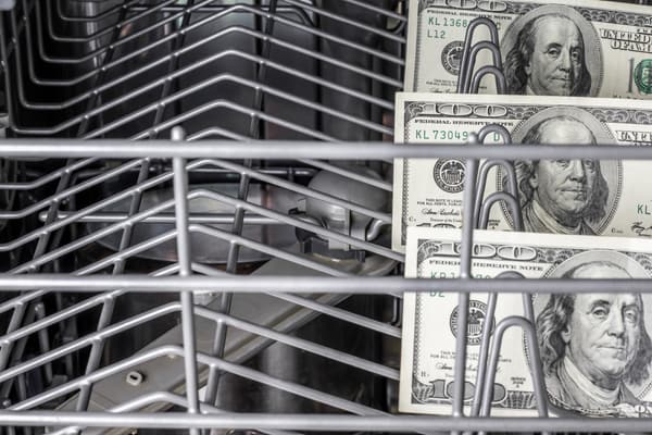 iStock Credit: Igor Nikushin $100 bills inside of a dishwasher